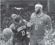  ?? DAVID J. PHILLIP — ASSOCIATED PRESS ?? The Rockets’ James Harden, left, drives toward New Orleans’ DeMarcus Cousins and the basket on Monday