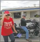  ?? (AP/Wong Maye-E) ?? Doris Miller, 86, (left), adjusts her cap after getting off the back of a motorcycle belonging to Jeff Bundren, 60, in Vienna, Ill. This is a deeply conservati­ve part of the nation — 77% of the county voted for President Donald Trump in the 2016 elections; just 19% went for Hillary Clinton.
