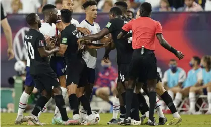  ??  ?? An official tries to break up a scuffle between players during the first half of USA’s World Cup qualifying draw with Canada. Photograph: Mark Humphrey/AP