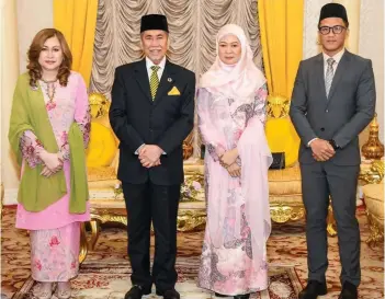  ?? — Informatio­n Department photo ?? Wan Junaidi and wife Toh Puan Fauziah Mohd Sanusi pose with Fenny (left) and a Foreign Ministry official during the courtesy call.