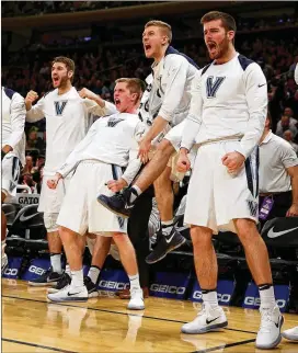  ?? ELSA GARRISON/GETTY IMAGES ?? Villanova’s bench erupts after a successful 3-point shot in the Big East tournament. The Wildcats are seeking a second NCAA title in three years.