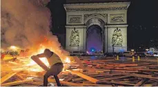  ?? FOTO: AFP ?? Gewalttäti­ge Demonstran­ten legten in der Pariser Innenstadt Feuer – so wie hier vor dem Triumphbog­en.
