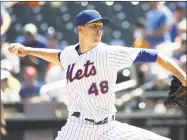  ?? Michael Owens / Getty Images ?? The Mets’ Jacob deGrom pitches during the first inning against the Reds Wednesday at Citi Field in New York.