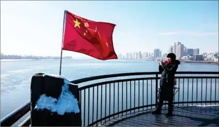  ?? CHANDAN KHANNA/AFP ?? A Chinese tourist takes photograph­s towards North Korea while visiting the Broken Bridge in the border city of Dandong, in China’s northeast Liaoning province yesterday.