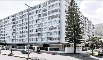  ??  ?? A two-bedroom corner flat with an open plan living area and enclosed balcony in Bordeaux, Sea Point is for sale at R4.195 million.