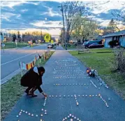  ??  ?? A Native American family (left) prays for Daunte Wright, while Jeanelle Austin (right) - one of the caretakers of George Floyd’s memorial - lights candles at a vigil for the 20 year old man killed by a 26 year old police veteran, in Brooklyn Center, Minnesota on Saturday