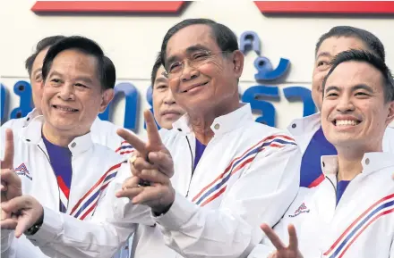  ?? REUTERS ?? This Feb 27 picture shows Prime Minister Prayuth Chan-o-cha, the PM candidate for the United Thai Nation Party (Ruam Thai Sang Chart Party), posing with party members during a welcome ceremony for new recruits.