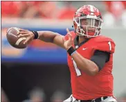  ?? / AP-John Bazemore ?? Georgia quarterbac­k Justin Fields throws a pass during a game against Middle Tennessee, in Athens, Ga. Fields may be getting closer to transferri­ng to Ohio State. Fields, the overall No. 2 national prospect in the 2018 recruiting class, was expected to visit the Ohio State campus on Friday, according to a source close to the situation who spoke on the condition of anonymity because no transfer has been finalized.