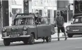  ?? Ismael Francisco / Associated Press ?? A driver pushes his vehicle to a gas station Thursday in Havana. Gas stations are running out with people still waiting in line.