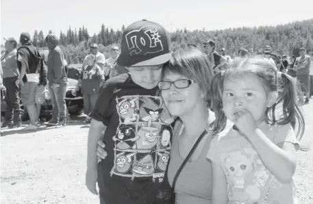  ?? Christina Ryan/calgary Herald ?? Melody Holloway hopes for reimbursem­ent for her home after the flood left her and her children, Justin and Kate, homeless on the Morley reservatio­n. She waited in line five hours to get a $1,250 debit card in the first round of assistance to flood...