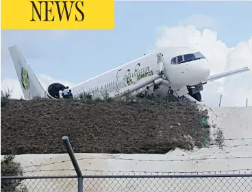  ?? DENIS CHABROL/AFP/GETTY IMAGES ?? A Toronto-bound Fly Jamaica airplane is seen after crash-landing at the airport in Georgetown, Guyana.