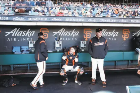  ?? Scott Strazzante / The Chronicle ?? Giants catcher Buster Posey (seated) and manager Bruce Bochy (right) are seen in the dugout during a 32 home win over the Dodgers on April 29. The Giants have gone 1914 since starting 2234 but would have to pass eight teams to earn a wildcard spot.