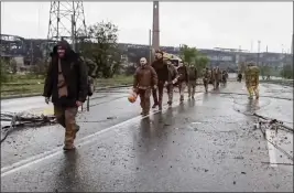  ?? RUSSIAN DEFENSE MINISTRY PRESS SERVICE VIA AP ?? In this image taken from video released by the Russian Defense Ministry on Thursday, Ukrainian servicemen leave the besieged Azovstal steel plant in Mariupol, in territory under the government of the Donetsk People's Republic, eastern Ukraine.