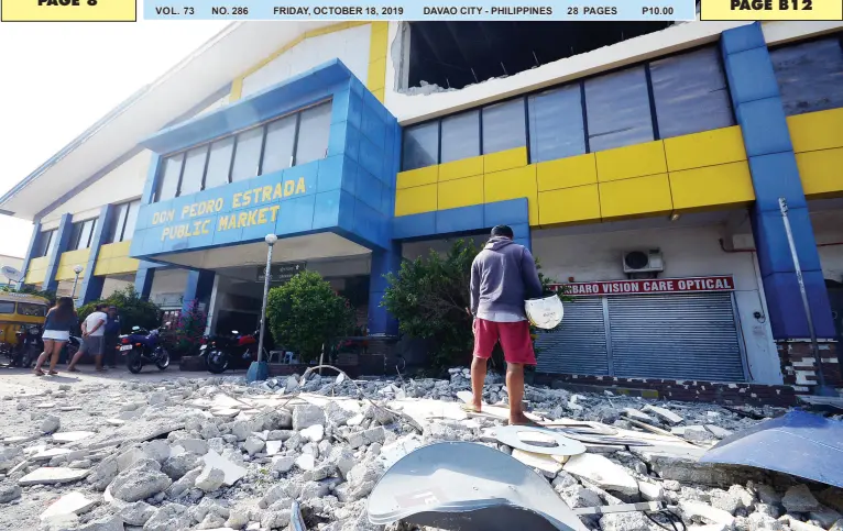  ?? BING GONZALES ?? DEBRIS fell off a collapsed wall of a public market in Digos City, Davao del Sur that damaged several establishm­ents after the earthquake that jolted Tulunan, North Cotabato and was felt in most parts of the island on Wednesday evening.