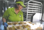  ?? BEA AHBECK/NEWS-SENTINEL ?? Sheila Webb, nutritiona­l services supervisor, gets pork carnita tacos ready as Lodi Unified School District debuts its new food truck at Elkhorn Elementary in Stockton on Wednesday.