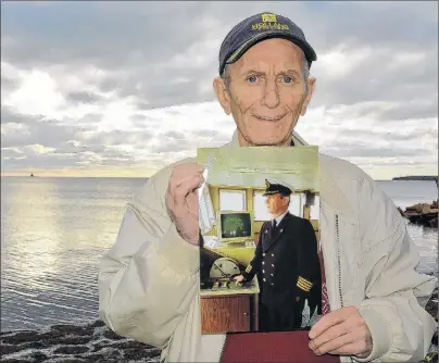  ?? DESIREE ANSTEY/JOURNAL PIONEER ?? Kevin Ranahan, one of the MV Vacationla­nd captains, says it’s dishearten­ing to see the vessel no longer in service. He holds a photo taken when he was a captain of the vessel that serviced P.E.I. to New Brunswick from 1971 to 1997.