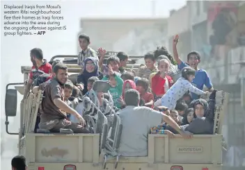  ?? — AFP ?? Displaced Iraqis from Mosul’s western Rifai neighbourh­ood flee their homes as Iraqi forces advance into the area during the ongoing offensive against IS group fighters.