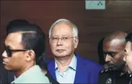  ?? LAI SENG SIN / REUTERS INDIA ?? Malaysia’s former prime minister Najib Razak (middle) arrives to give a statement to the Malaysian Anti-Corruption Commission in Putrajaya, Malaysia, on Tuesday.