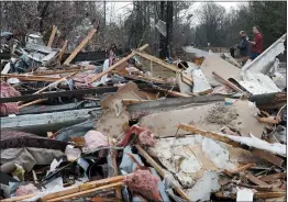  ?? BUTCH DILL — THE ASSOCIATED PRESS ?? National Weather Service members survey damage Wednesday in Flatwood, Ala., following a severe storm the day before.