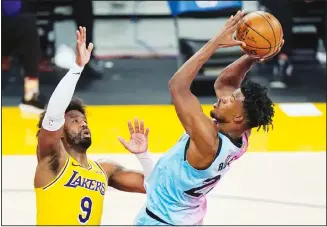  ?? (AP) ?? Miami Heat forward Jimmy Butler (right), shoots as Los Angeles Lakers guard Wesley Matthews defends during the second half of an NBA basketball game, on Feb 20, in Los Angeles.