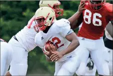  ?? Jeremy Stewart / Rome News-Tribune ?? Rome High running back Nick Burge carries the ball through traffic during spring practice Thursday at Rome High School.