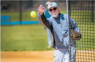  ?? ?? Larry Roberts pitches during softball practice at Centennial Park.