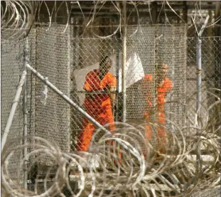  ?? Photo: Nampa/AFP ?? Confinemen­t… In this file photo, taken on 27 January 2002, a detainee from Afghanista­n wipes himself down as another detainee looks out from his enclosure at Camp X-Ray at Guantanamo Bay, Cuba.