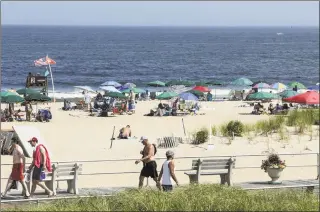  ?? Kena Betancur / Getty Images ?? People visit the beach on Saturday in Ocean Grove, N.J. An excessive heating warning is affecting nearly twothirds of the United States where more than 195 million people will experience temperatur­es above 90 degrees over the next few days.