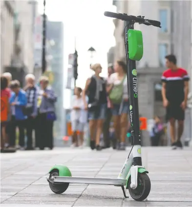  ?? CHRISTINNE MUSCHI / NATIONAL POST FILES ?? Despite recent staffing cuts, a Lime spokespers­on said the e-scooter company is “fully committed” to Canada and “as
more cities adopt or restart scooter programs, we will add team members to oversee those operations.”