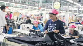 ?? PROVIDED TO CHINA DAILY ?? Workers make garments at a factory in the Sihanoukvi­lle SEZ in Cambodia. Backed by the Chinese and Cambodian government­s, the SEZ was developed by Wuxi-based Hodo Group and Cambodia Internatio­nal Investment Developmen­t Group in 2007.