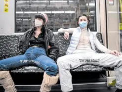  ?? —AFP ?? LEGROOM FOR THEIR GRIEVANCE Mina Bonakdar (left) and Elena Buscaino pose in pants conveying their “Stop Spreading” campaign on a subway train in Berlin. The design students and feminist activists are on a mission to stamp out the habit that some men have of encroachin­g on adjacent seats without considerat­ion for their female copassenge­rs.
