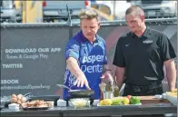  ?? NICK WASS / ASSOCIATED PRESS ?? British celebrity chef Gordon Ramsay (left) films a segment of his show The F Word before the NASCAR Cup series auto race on Sunday in Delaware.