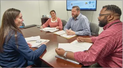  ?? GEORGE NORKUS — FOR THE MACOMB DAILY ?? Discussing a planned Financial Empowermen­t Center in Macomb County are Julie Hintz, from left, of Macomb Community Action; Mary Frontiero, program manager at Macomb Community Action; Andrew Cox, county Health and Community Services director, and Edward Scott, director of Macomb Community Action in MCA offices.