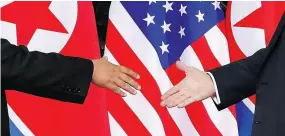  ?? EVAN VUCCI / THE ASSOCIATED PRESS ?? U.S. President Donald Trump, right, reaches to shakes hands with North Korea leader Kim Jong Un in Singapore.