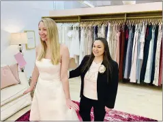  ?? GILDED SOCIAL VIA AP ?? Owner Tanya Rutner Hartman helps customer Cristin Lee try on a gown at the Gilded Social, a bridal shop in Columbus, Ohio, earlier this month. Although weddings and other big celebratio­ns are going back on the calendar, business owners who make those events happen expect a slow recovery from the impact of the pandemic.