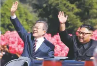  ??  ?? South Korean President Moon Jae-in, left, and North Korean leader Kim Jong-un wave from a car Tuesday during a parade in Pyongyang, North Korea.