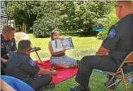  ?? CHRIS BARBER — DIGITAL FIRST MEDIA ?? Brittany, a member of the Study Buddies after-school program, reads to local police.