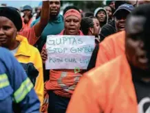  ?? AFP via Getty Images/Marco Longari ?? On strike: Optimum workers hand a memo to the company’s CEO in February 2018