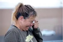  ?? ANDRES LEIGHTON/ASSOCIATED PRESS ?? Edie Hallberg cries while speaking to police outside the Walmart store as she looks for her missing mother, Angie Englisbee, who was in the store during the attack.