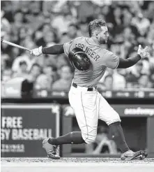  ?? Elizabeth Conley / Staff photograph­er ?? George Springer’s helmet goes flying after a mighty swing, but, unfortunat­ely for the Astros, the ball did not. Springer later left Friday’s game after hurting his shoulder trying to make a catch.