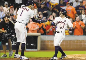  ?? DAVID J. PHILLIP— ASSOCIATED PRESS ?? Jose Altuve, right, celebrates his solo home run — his third of the game against Boston — with teammate Carlos Correa.