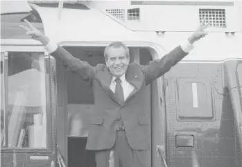  ?? BOB DAUGHERTY/AP ?? Richard Nixon salutes his staff on Aug. 9, 1974, outside the White House after resigning the presidency.