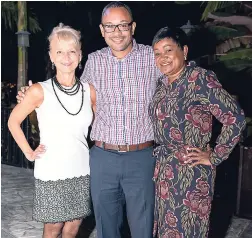  ??  ?? Chief Operating Officer of RJRGleaner Communicat­ions Group Christophe­r Barnes is flanked by President and CEO of JPS Kelly Tomblin (left) and JPS board member Minna Israel.