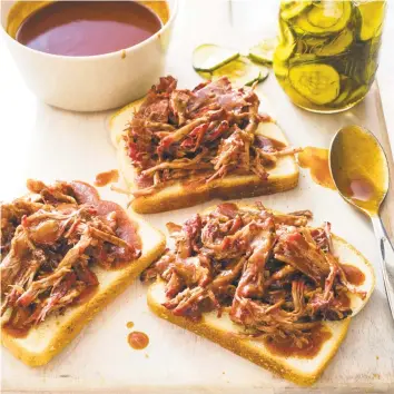  ?? Carl Tremblay / AP ?? Shredded Barbecued Beef can be served on plain white bread with plenty of pickle chips.
