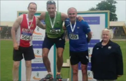  ??  ?? Ardee & District’s Michael Lundon (wearing blue) on the podium after finishing third at the National Combined Events Championsh­ip.