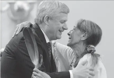  ?? SEAN KILPATRICK/THE CANADIAN PRESS ?? Prime Minister Stephen Harper hugs Elder Evelyn Commanda-Dewache, a residentia­l school survivor, during Wednesday’s closing ceremony of the Indian Residentia­l Schools Truth and Reconcilia­tion Commission at Rideau Hall.