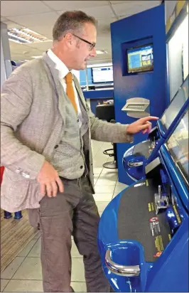  ??  ?? A BETTING MAN: Toby tries out the self-service machine at William Hill