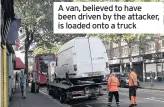  ??  ?? A van, believed to have been driven by the attacker, is loaded onto a truck