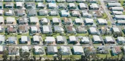  ?? MIAMI HERALD ?? An aerial view of the damaged homes caused by Hurricane Ian seen in the vicinity of Fort Myers on Sept. 29, 2022.