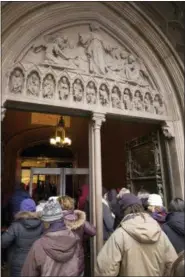  ?? MARK LENNIHAN — THE ASSOCIATED PRESS ?? In this photo, visitors to Trinity Church wait in line to pass through metal detectors in New York. Two New York City churches that survived the destructio­n of World Trade Center have become the latest city tourist sites to embrace post-9⁄11 security...